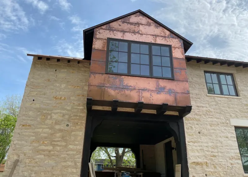 Copper metal panel facade on a stone building for Metal Roof Coating in Summit